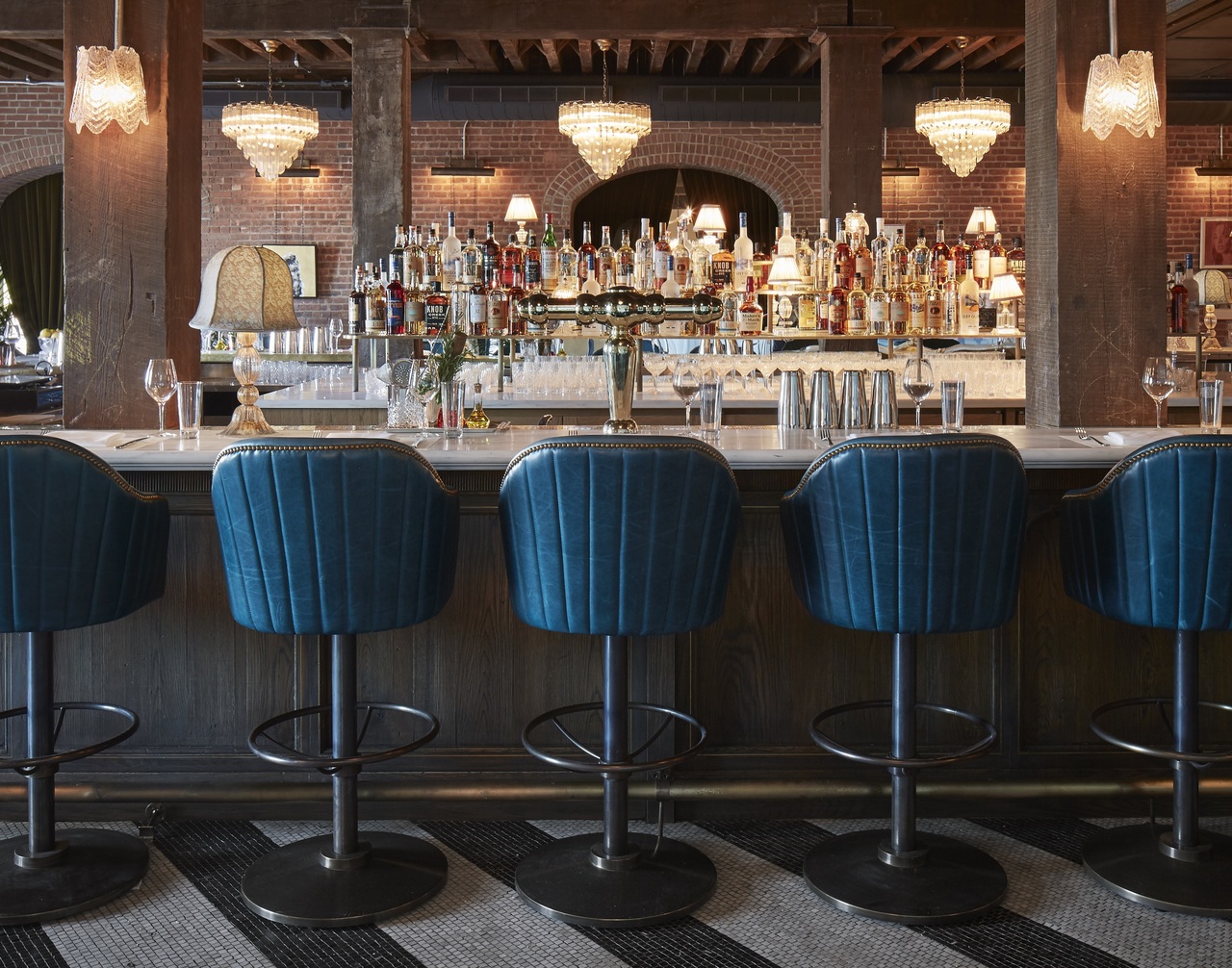 A bar, leather stools and classic Italian furnishings